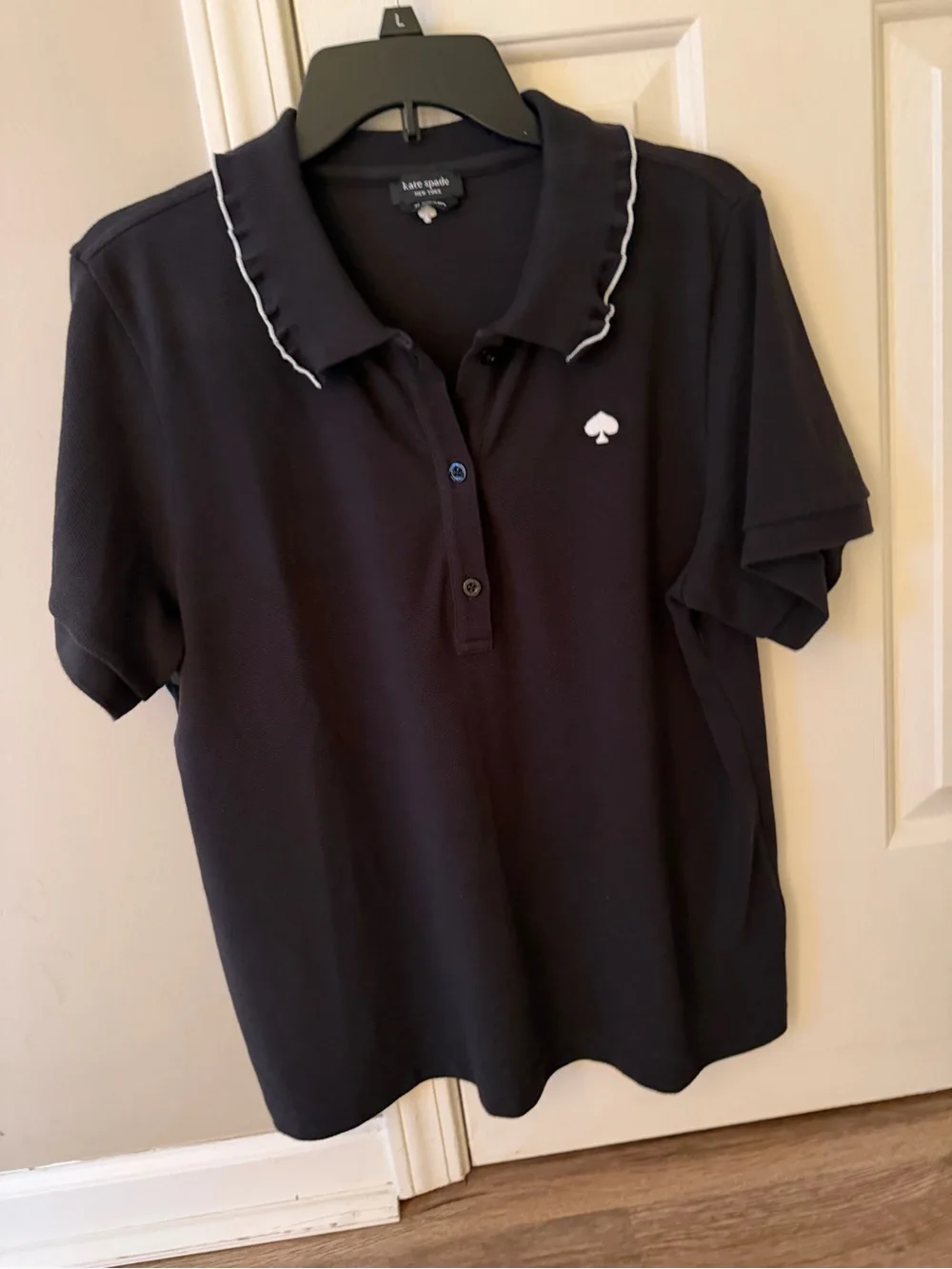 kate spade black polo top with white trim and embroidered logo.